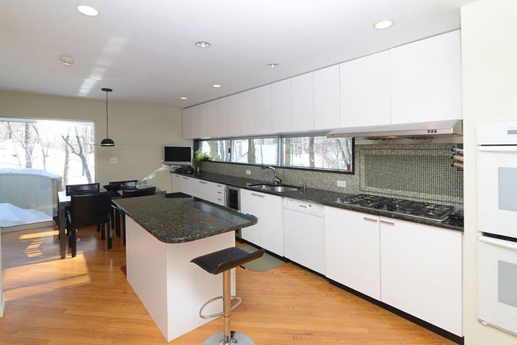 Modern white kitchen with black pearl granite countertops