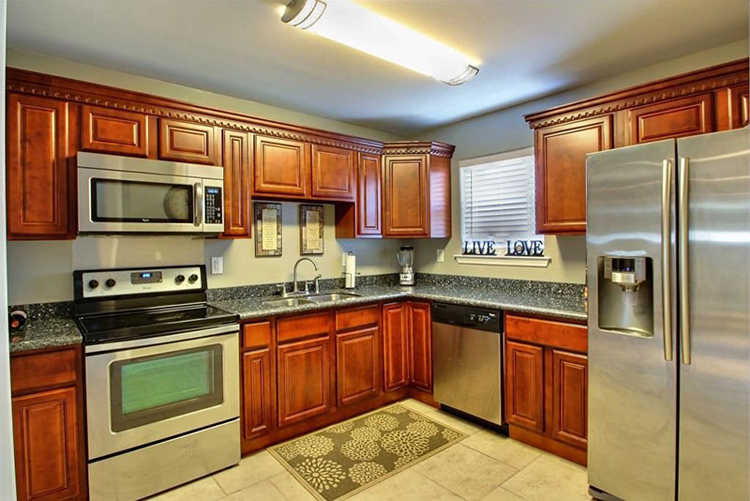 Cherry cabinets with blue pearl countertops