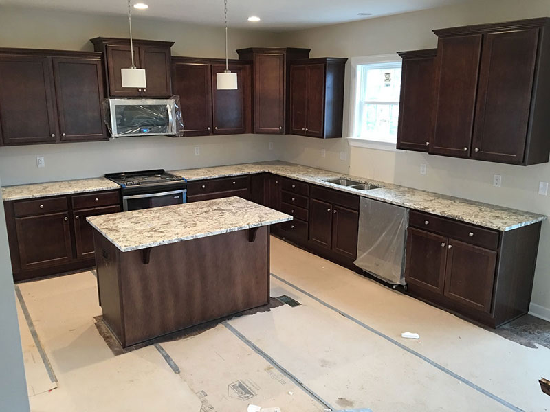 Kitchen With Dark Cabinets And White Spring Granite Countertops