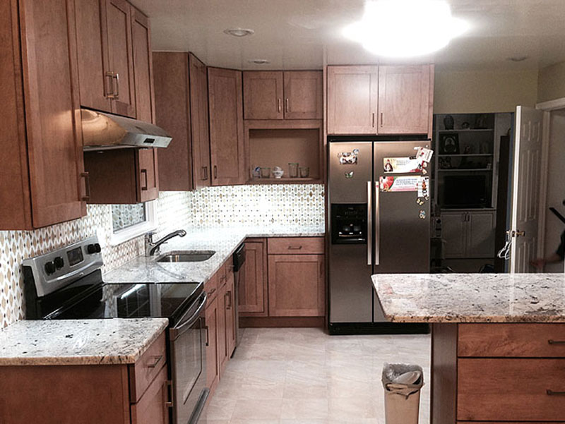 Kitchen With Maple Cabinets And Glacier White Granite Countertops