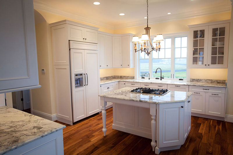 Kitchen With White Cabinets And Supreme White Granite Countertops