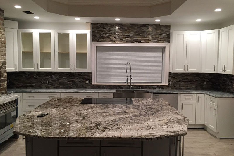 Kitchen With White Cabinets And White Tiger Granite Countertops